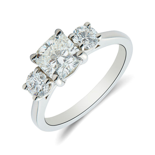 Platinum cushion & round brilliant cut diamond trilogy ring. Henry D Johnstone Jewellers. Alderley Edge, Poynton, Cheshire.