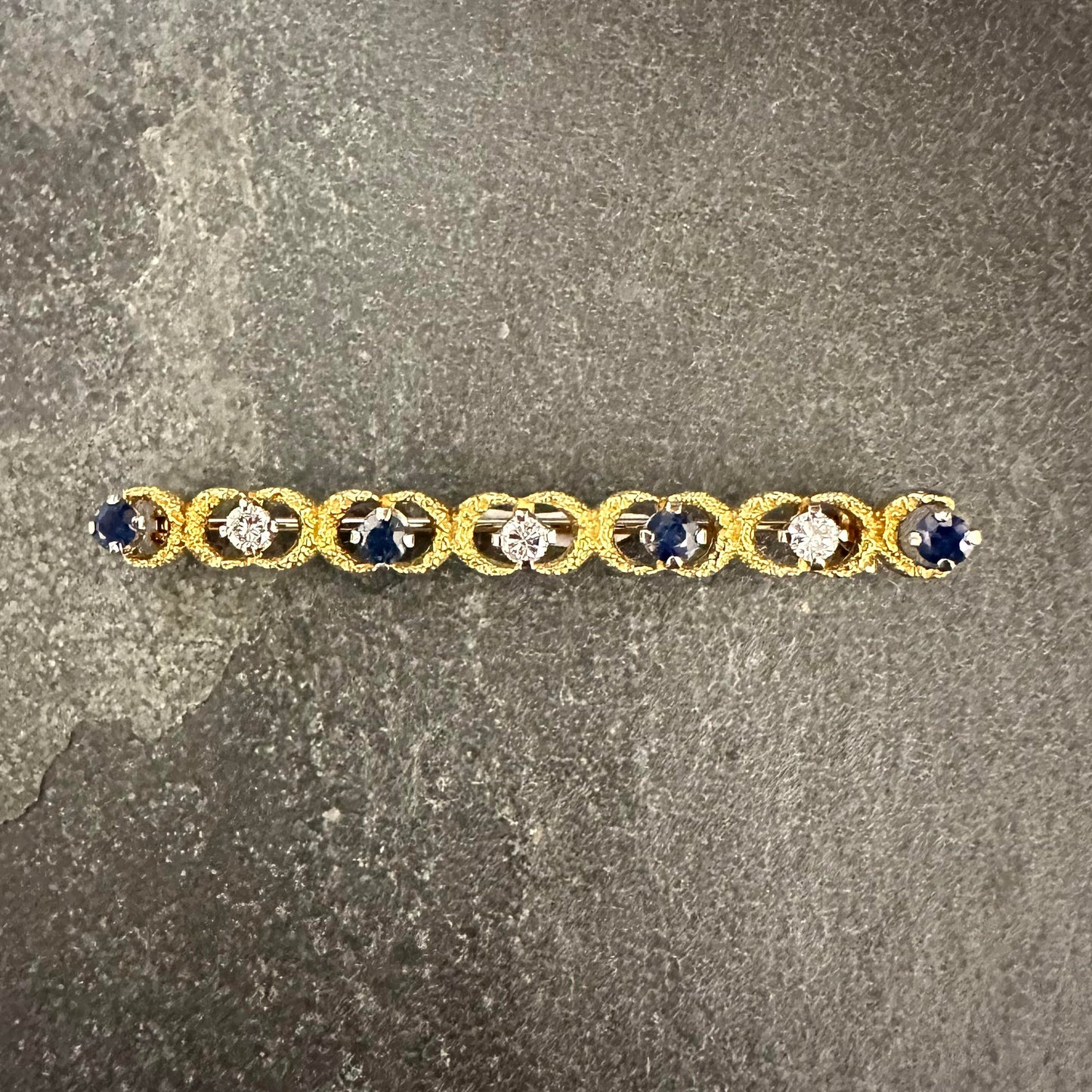Pre-Owned One 18ct gold sapphire and diamond set textured bar brooch.