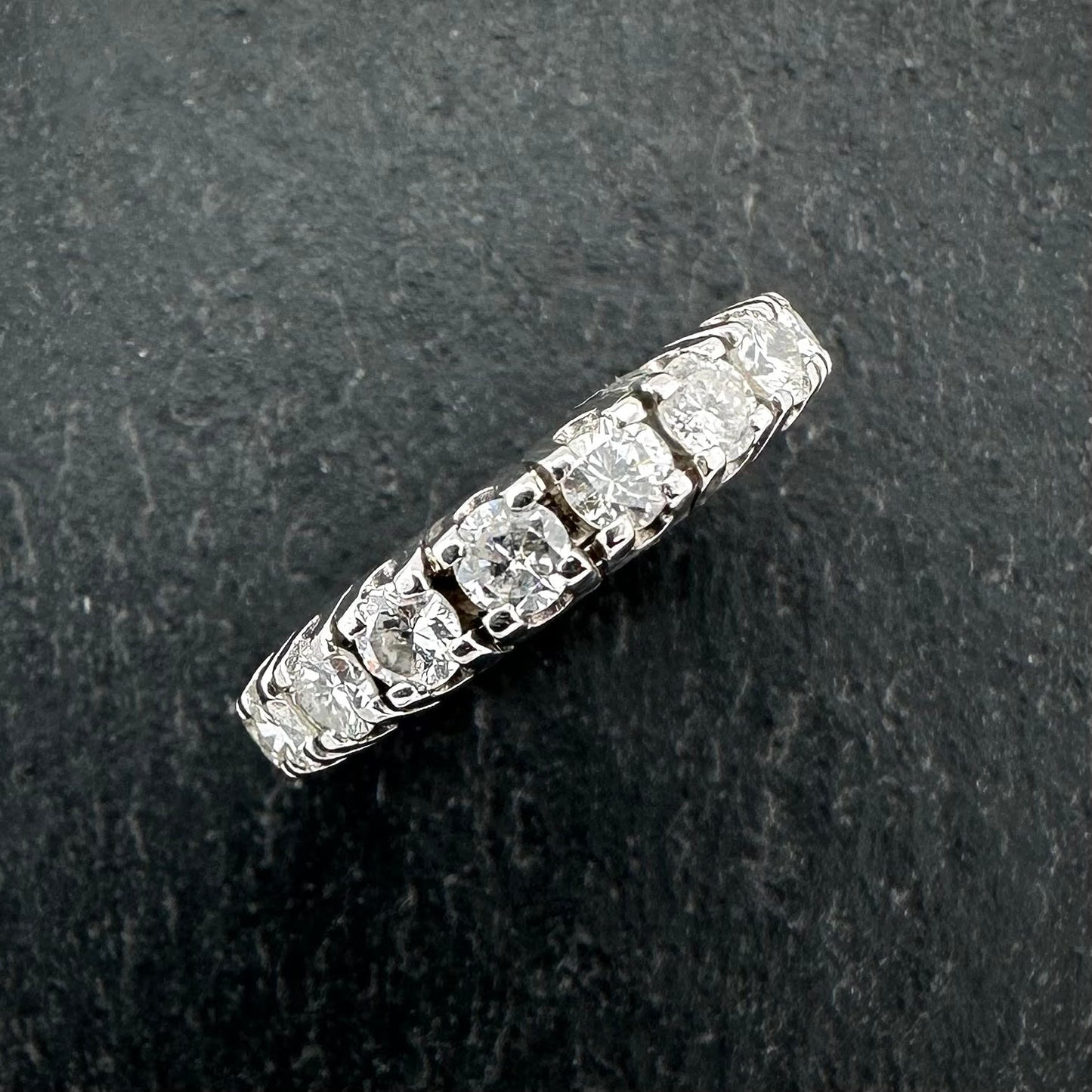 Pre-Owned: One precious white metal round brilliant cut diamond claw set eternity ring - Full hoop.