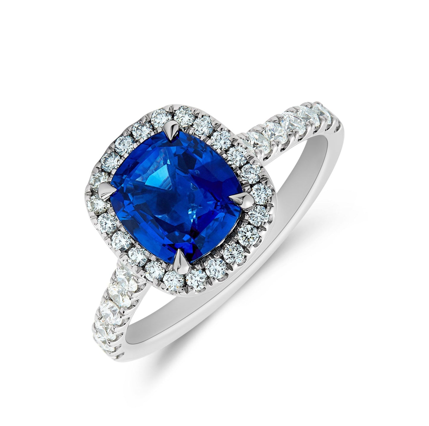 Platinum & cushion cut sapphire, surround of diamond set halo with diamond set shank. Henry D Johnstone Jewellers. Alderley Edge, Poynton, Cheshire.