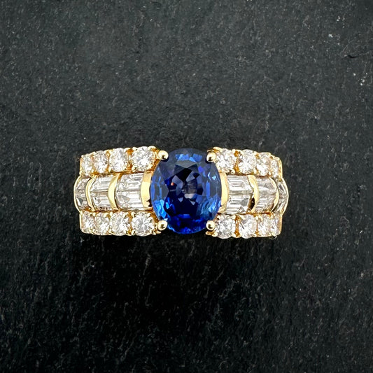 Pre-Owned: Precious yellow metal sapphire & round brilliant & emerald cut diamond set dress ring.