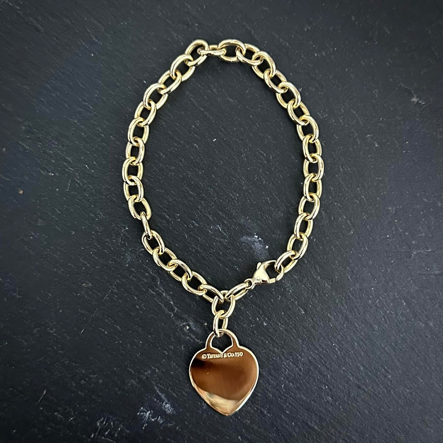 Pre-Owned: Precious yellow metal  'Tiffany & Co' heart charm bracelet.
