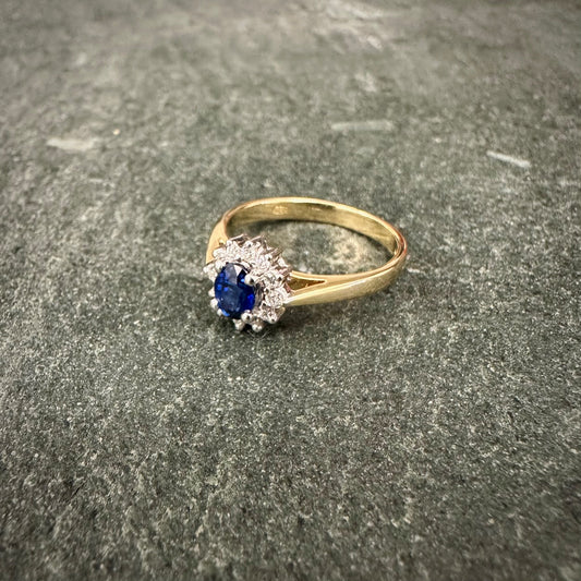 Pre Owned: 18ct gold oval sapphire and brilliant cut diamond cluster ring. - 0.45ct