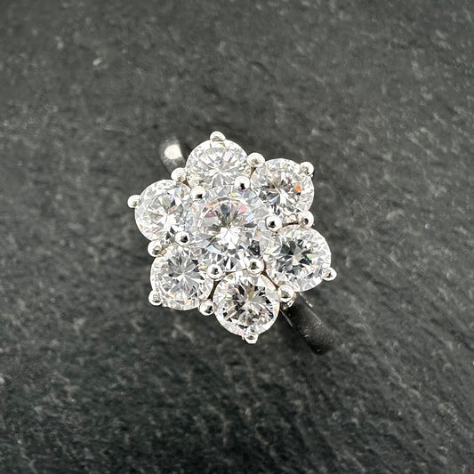 Pre-Owned: One 9ct White gold seven stone flower cluster ring set with CZ stones.