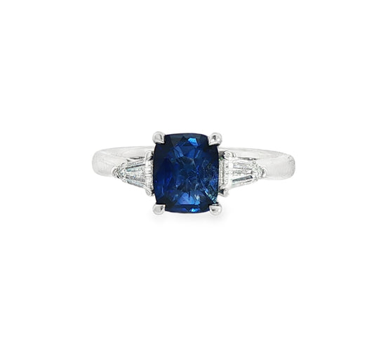 Platinum cushion shaped sapphire & bullet cut diamond three stone ring.