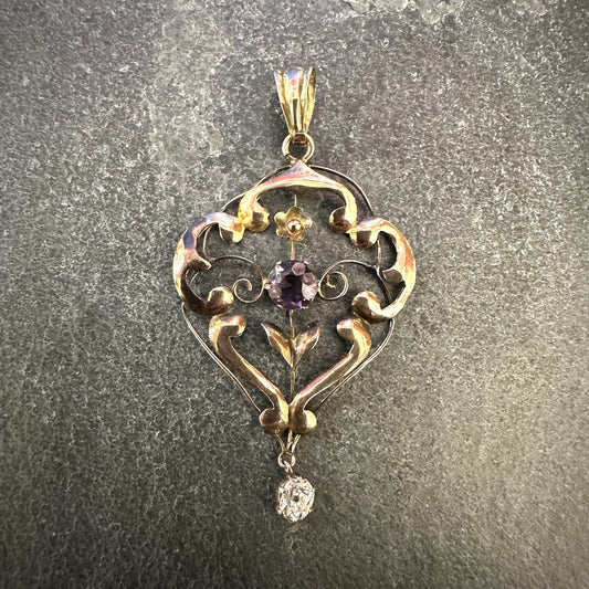 Pre-Owned: precious rose metal filigree open work pendant set with amethyst and diamond drop.
