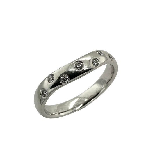 Precious white metal ring, set with round brilliant cut diamonds in a rub over setting. Henry D Johnstone Jewellers. Alderley Edge, Poynton, Cheshire.