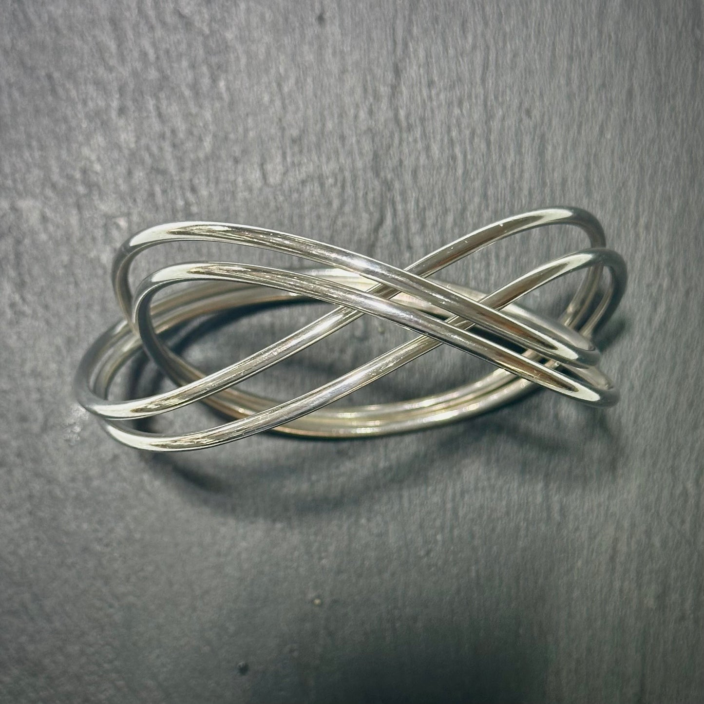 Pre-Owned: One George Jensen sterling silver intertwined bangle.