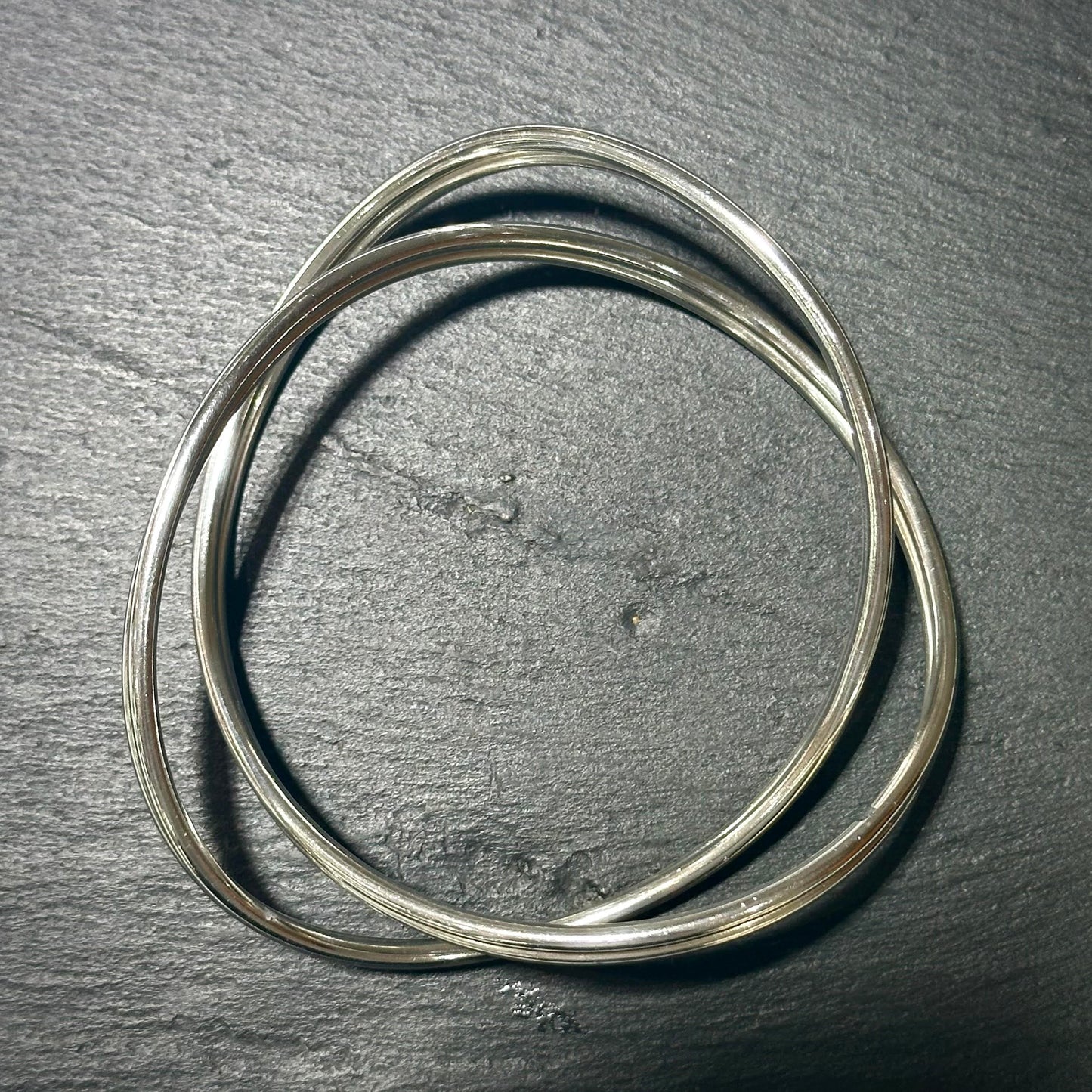 Pre-Owned: One George Jensen sterling silver intertwined bangle.