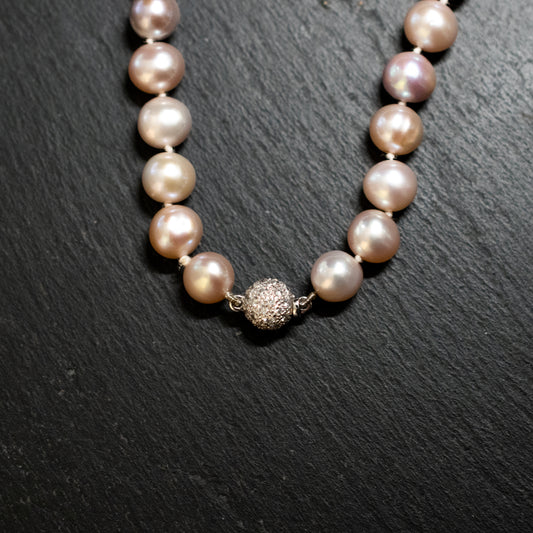 Pre-Owned: One cultured pearl row necklace with a diamond set clasp.