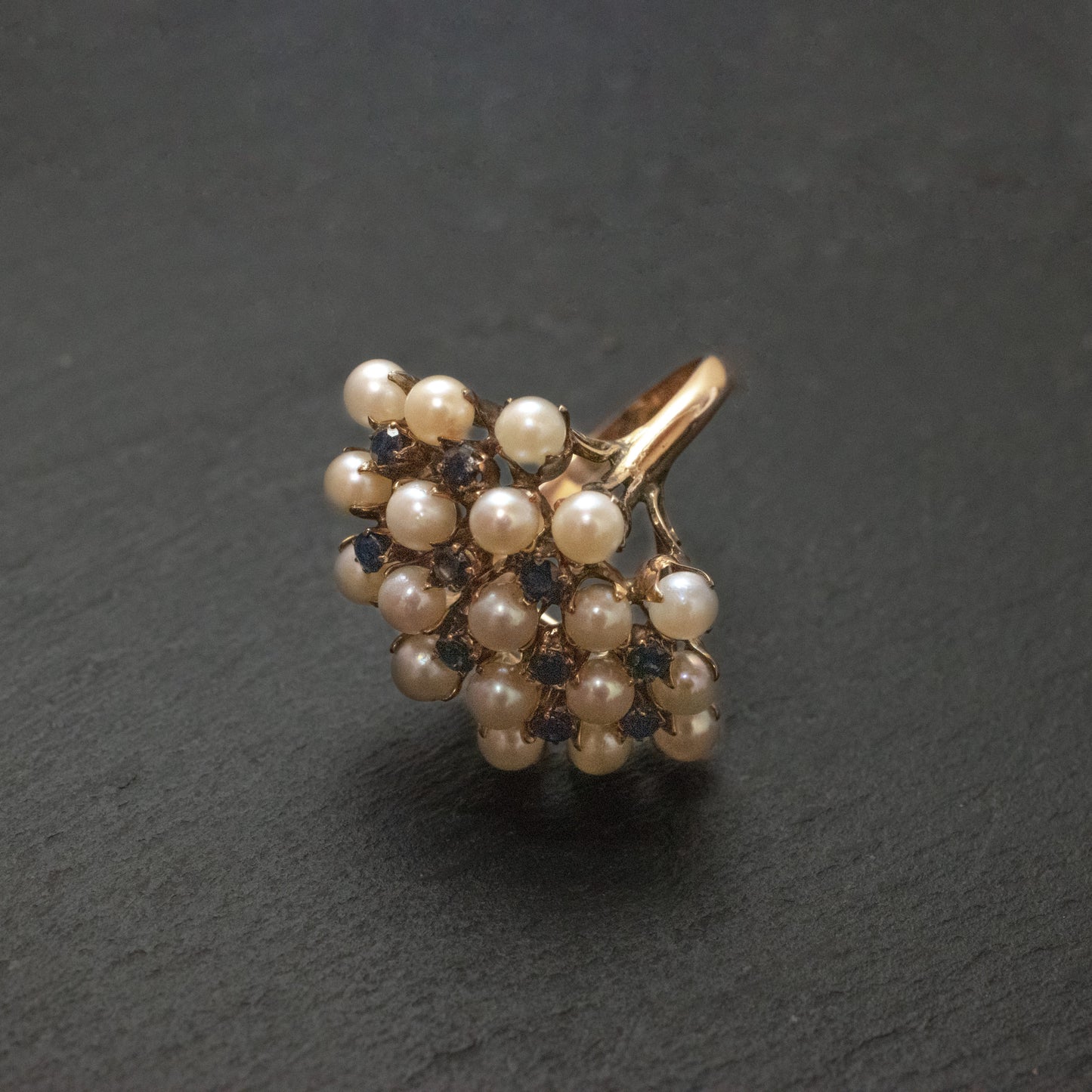 Pre-Owned: One precious yellow metal pearl and sapphire cluster ring.