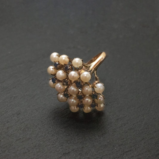 Pre-Owned: One precious yellow metal pearl and sapphire cluster ring.