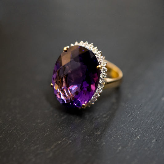 Pre-Owned: One precious yellow metal oval cut amethyst and diamond cluster ring. - 1.02ct.