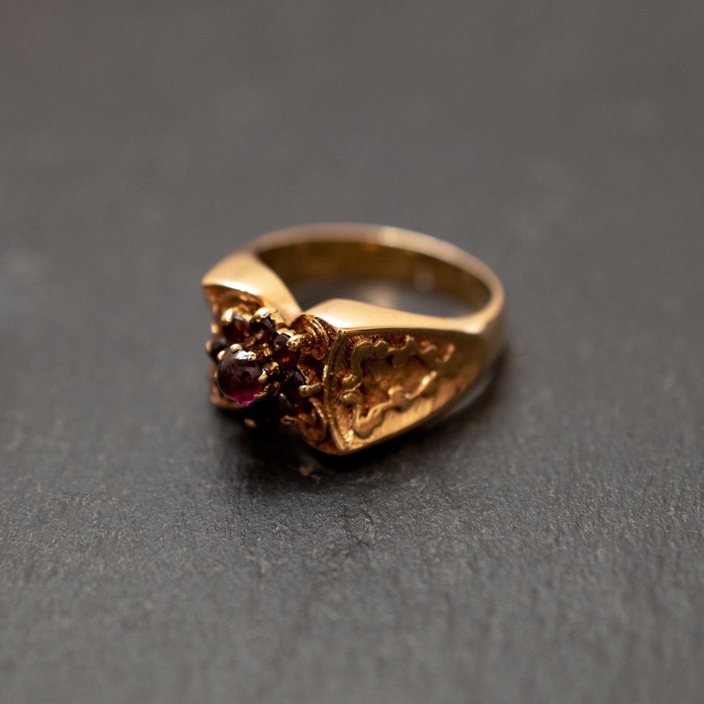 Pre-Owned: One precious yellow metal garnet cluster dress ring.