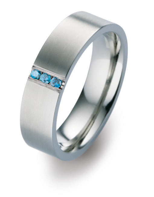 Matte titanium wedding band with three treated blue diamonds in channel setting. Henry D Johnstone Jewellers. Alderley Edge, Poynton, Cheshire.