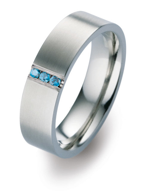 Matte titanium wedding band with three treated blue diamonds in channel setting