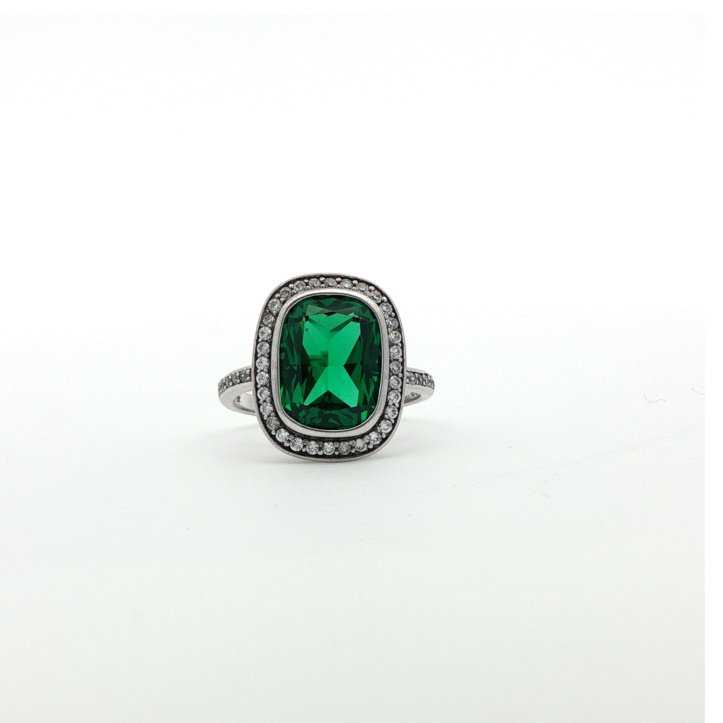 Carat Cushion cut & Emerald simulant ring with halo of white stones.