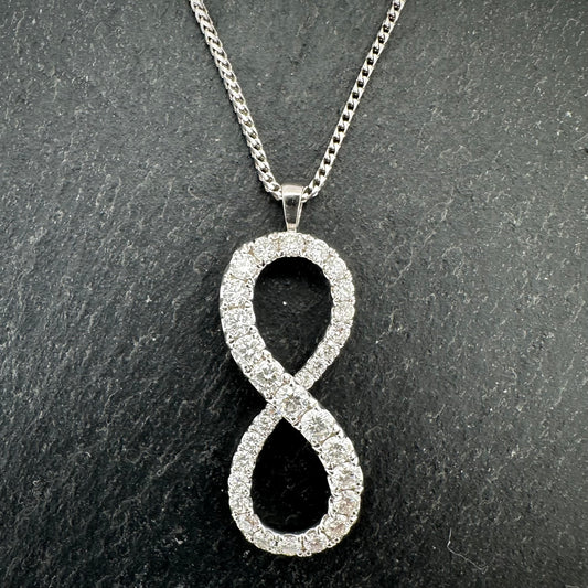 Pre-Owned: 18ct white gold diamond set 'infinity' pendant suspended from 18ct white gold chain.