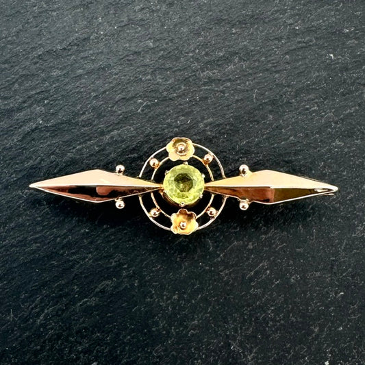 Pre-Owned: Precious yellow metal and green peridot brooch.