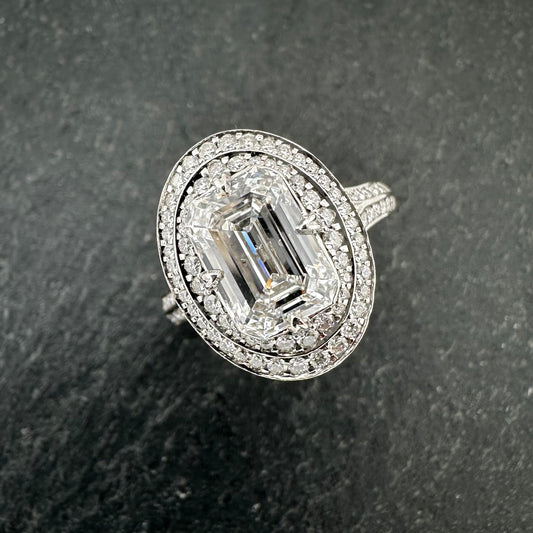 Pre-Owned: Platinum emerald cut diamond solitaire ring with diamond set double halo - 2.03ct