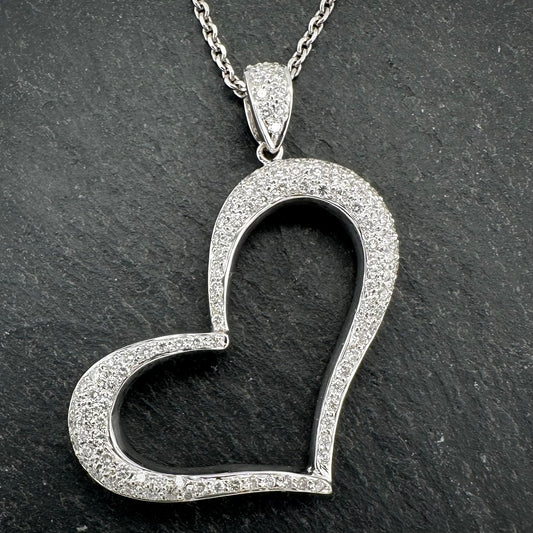 Pre-Owned: 18ct white gold diamond set open 'Heart' shaped pendant suspended from a 9ct white gold chain.