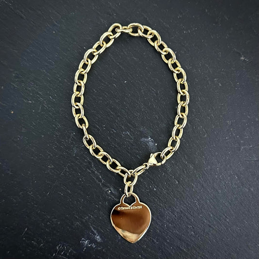 Pre-Owned: Precious yellow metal  'Tiffany & Co' heart charm bracelet.