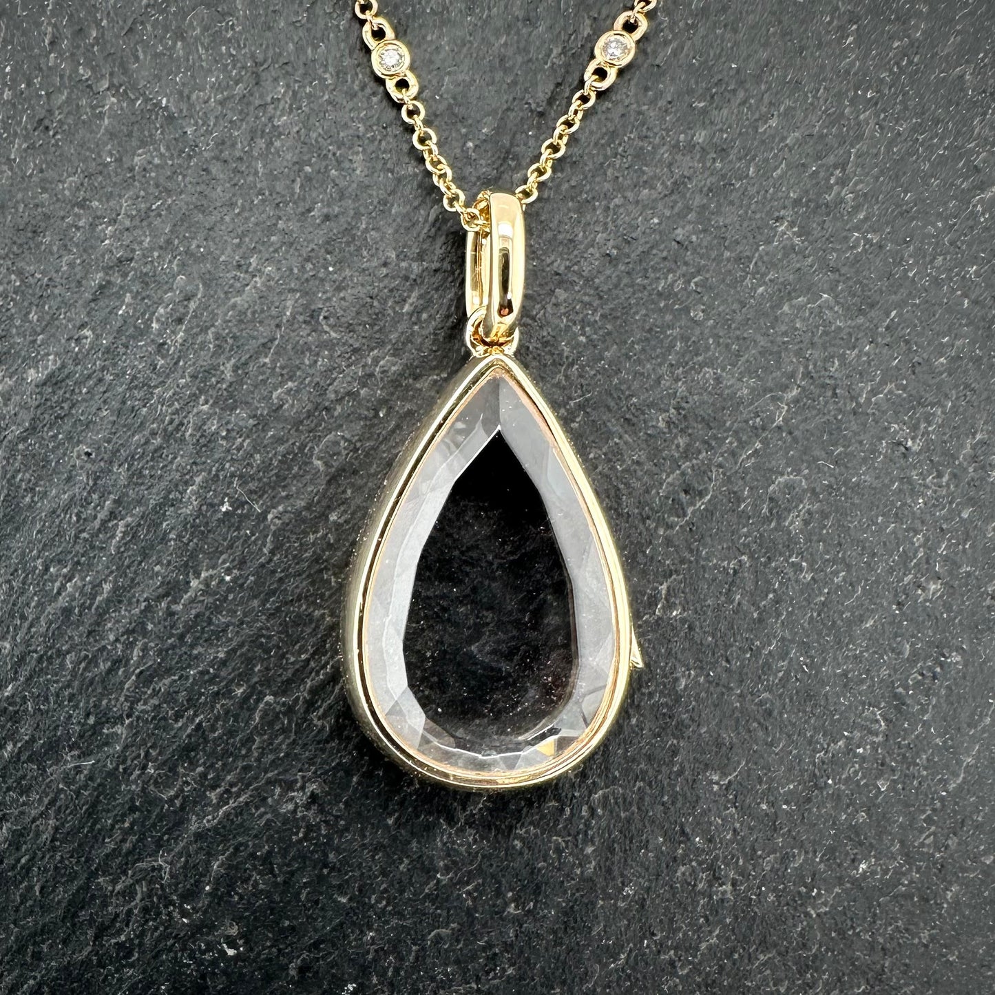 Pre-Owned: Precious yellow metal pear shaped 'Saffron' locket by 'Loquet' on diamond set trace chain.