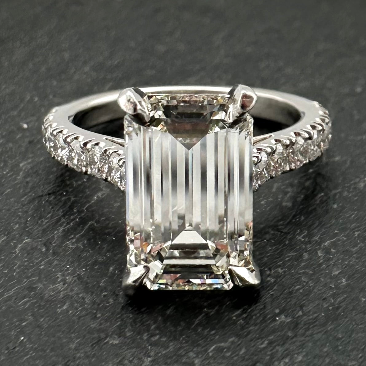 Pre-Owned: Precious white metal emerald cut diamond solitaire ring with diamond set shoulders - 2.43ct