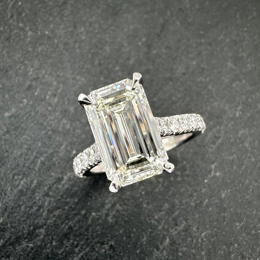 Pre-Owned: Precious white metal emerald cut diamond solitaire ring with diamond set shoulders - 2.43ct