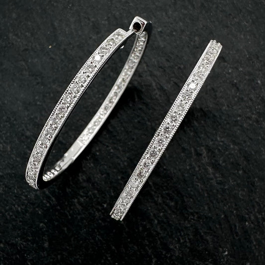 Pre-Owned: One pair of precious metal diamond set hoop earrings.
