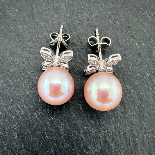 Pre-Owned: Precious white metal diamond set floral style pearl drop earrings.