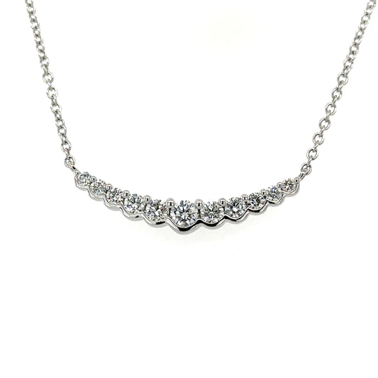 18ct white gold 11 stone diamond graduated curved bar pendant on chain.