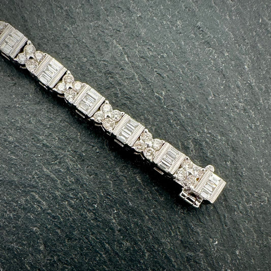 Pre-Owned: Precious white metal round brilliant & emerald cut diamond set bracelet. 4.01ct.