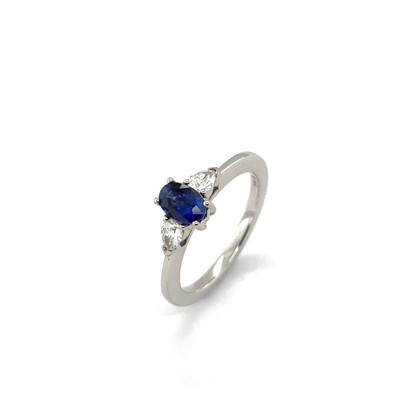 18ct white gold oval blue sapphire and pear cut diamond 3st ring - S0.74ct/D0.27ct.