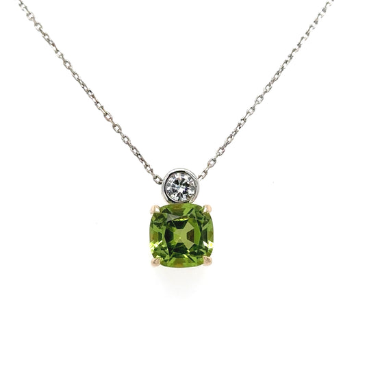 9ct yellow & white gold cushion cut peridot brilliant cut diamond pendant on fine trace chain.