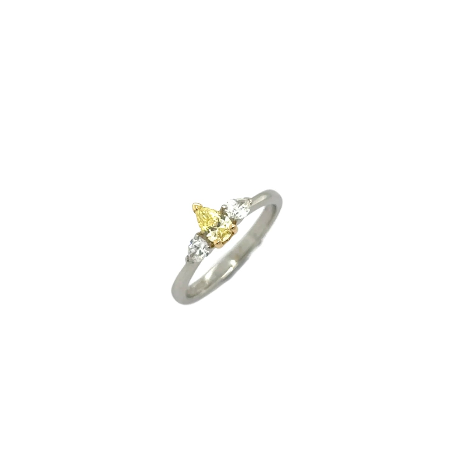 Platinum pear cut diamond three stone ring - 0.31ct Fancy Intense Yellow / 0.30ct.