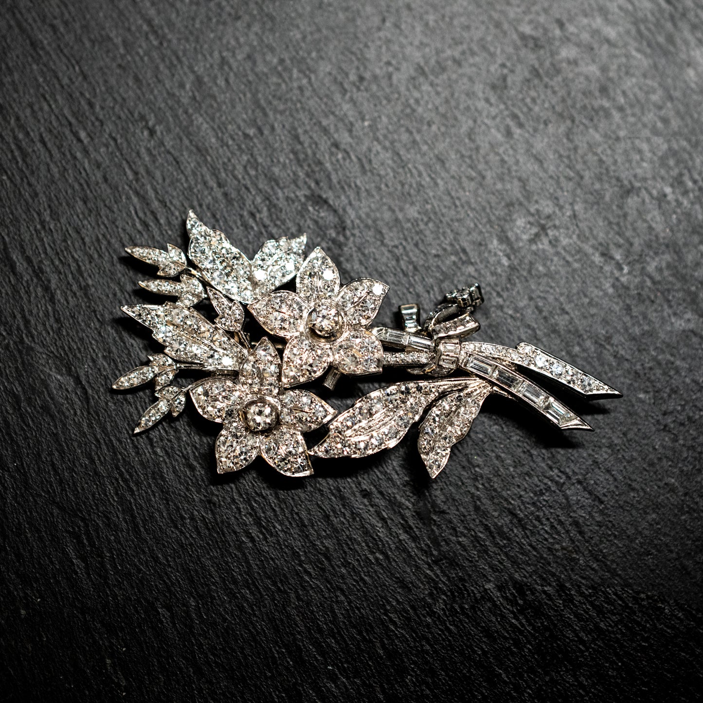 One precious white metal diamond set floral spray brooch
