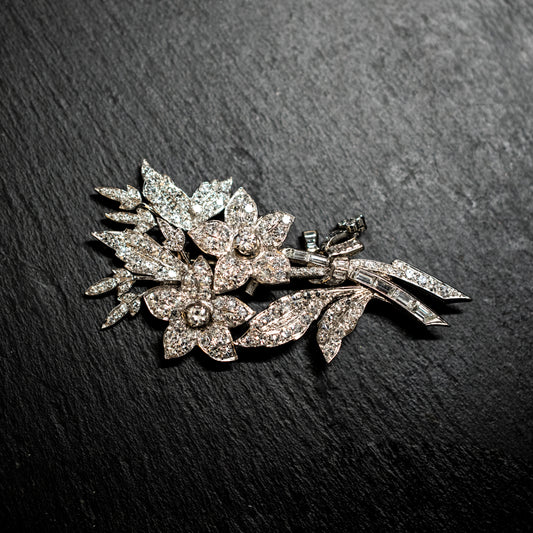 One precious white metal diamond set floral spray brooch