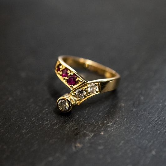 00016180 Pre-Owned: One precious yellow metal ruby and diamond wishbone ring - 0.27ct.