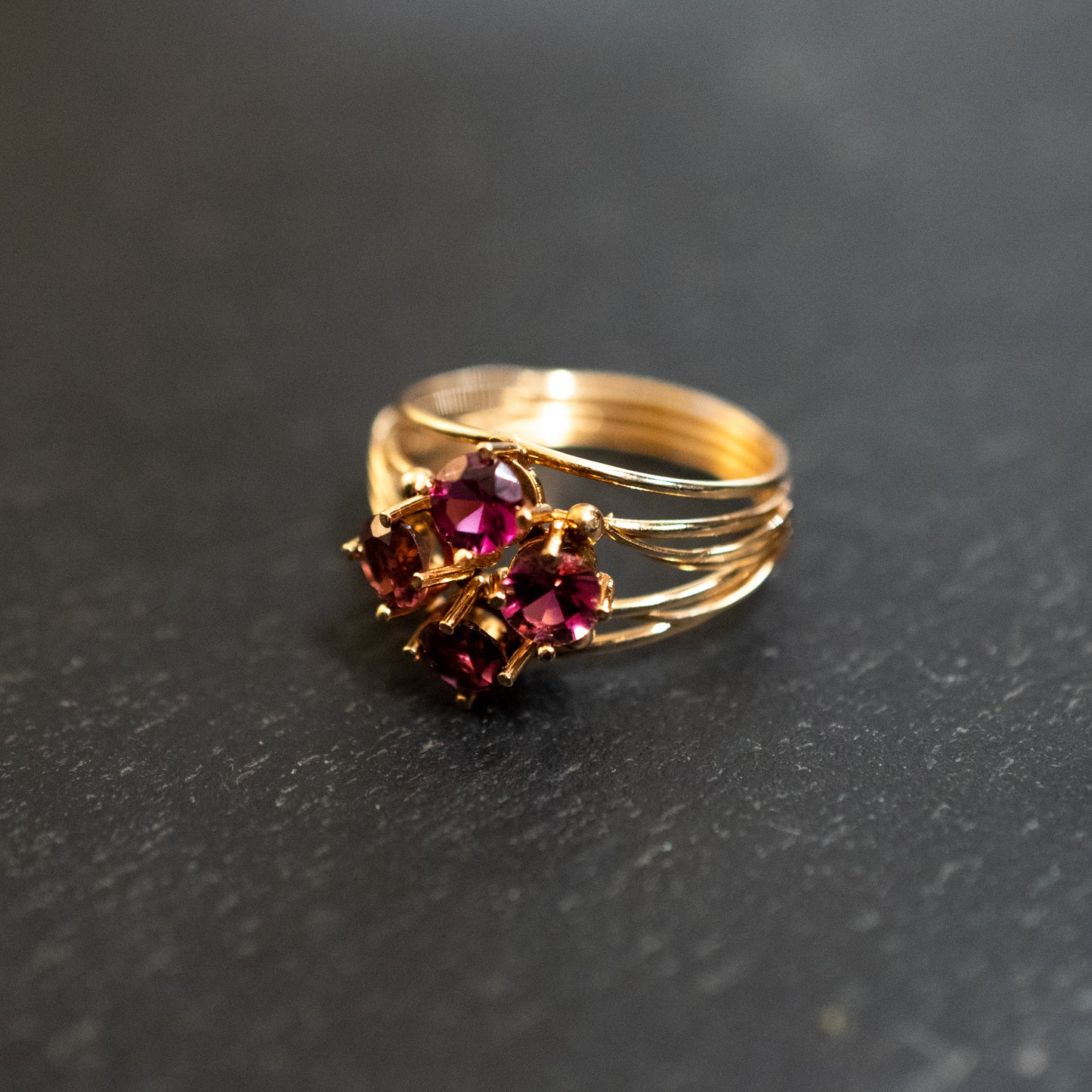 Pre-Owned: One precious yellow metal pink tourmaline four stone cluster ring.